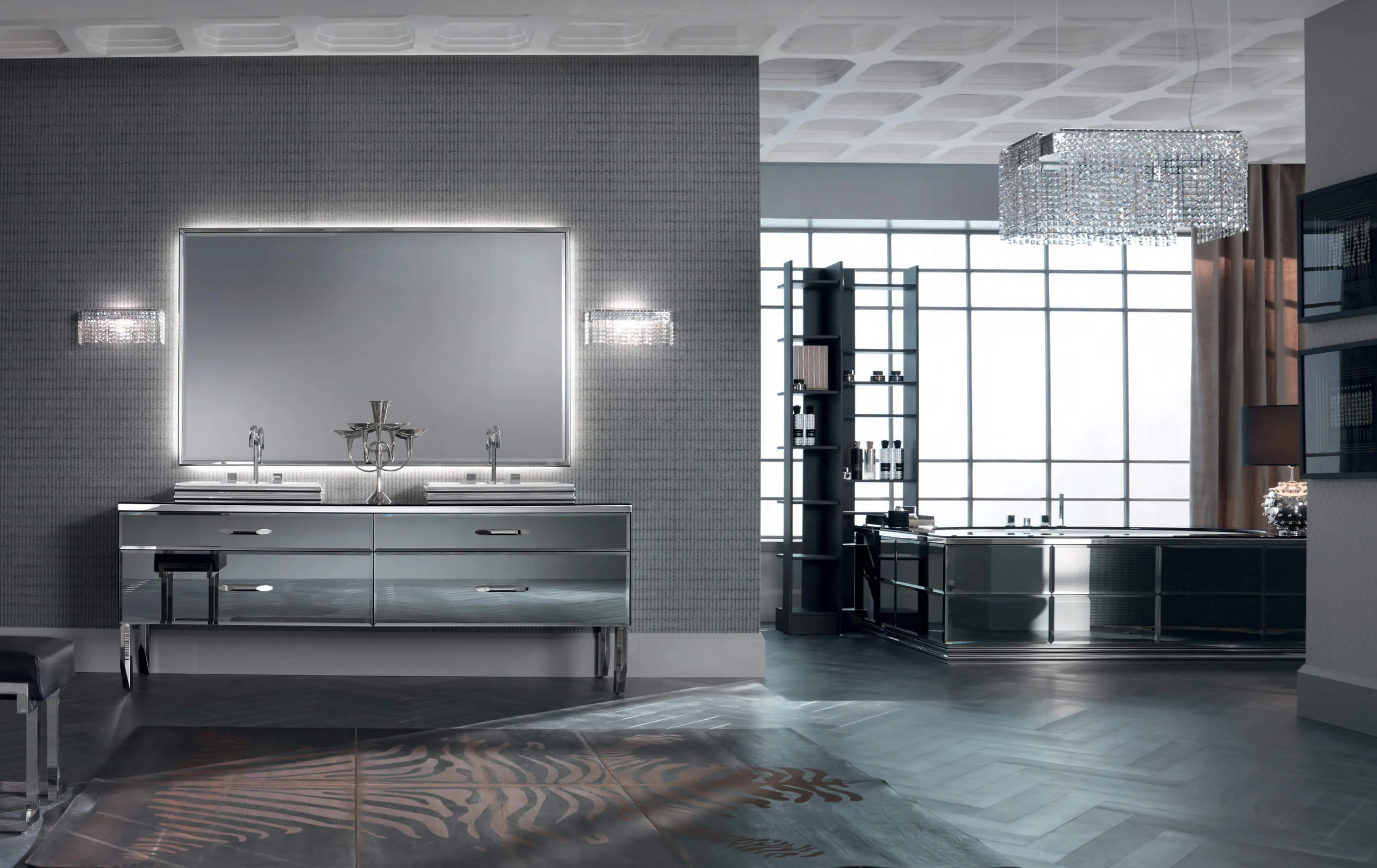 Ein Badezimmer wie vom Profi entsteht, wenn einfache Linien mit exklusiven Materialien verbunden werden. Diese Vision verwirklichten die Designer in der Ritz Kollektion: Inspiriert von klassischen Formen der Möbelstücke aus dem Goldenen Zeitalter wurden diese mit einem untrüglichen zeitgemäßen Finish in das 21. Jahrhundert befördert. Essentielle, eindrucksvolle Möbelstücke profitieren von der scheinbar nackten Linienführung. Geometrisch scharfe Paneele auf den Fronten der Waschtischunterschränke und im Inneren des Waschbeckens setzten ein starkes und selbstbewusstes Statement. Durch den Einsatz zeitloser Materialien, wie Marmor, Glas und Edelstahl entsteht ein luxuriöser Eindruck, der das Stilgefühl des Eigentümers und seine geradlinige Natur unterstreicht. 