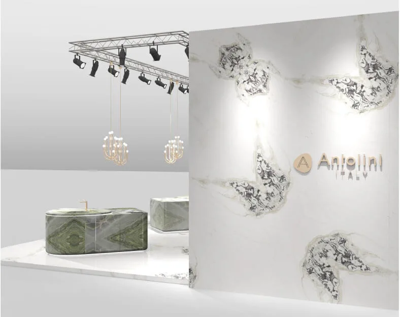 Anmut und Eleganz für eine kostbare, traumhafte Kulisse Antolini erklärt seine Präsenz auf der BAU mit einer durchdachten Installation, die vom Designer Alessandro La Spada entworfen wurde. Antolini ist ein Synonym für Exzellenz in der Natursteinbranche und präsentiert sich in München mit einem Ausstellungsraum, der fließend, offen, filigran und gleichzeitig energisch ist. Die vom Designer Alessandro La Spada entworfene Installation empfängt die Besucher mit einer Atmosphäre von fast magischen Tönen: einem harmonischen und eindrucksvollen Bodenbelag aus Dover White (in Lederoptik) sowie einer äußerst suggestiven Wand aus Irish Green | Stratos Design, das dank der neuen Diagonalvene den Betrachter mit seinem verträumten und anmutigen Charakter besticht. Äußerlich bietet eine weiße Wand, ebenfalls in Dover White (in poliertem Finish), einfallsreiche, diagonal verlegte Bookmatch-Platten, die vergängliche organische Elemente hervorrufen. In der Mitte der Installation befinden sich zwei Küchenblöcke mit weichen und abgerundeten Formen, die aus frischen, grünen und hellgrauen Tönen aus poliertem irischem Naturstein Naturstein erstellt wurden, der mit seinen irisierenden Ton-to-Ton-Tönen ein Muster bildet, das natürlichen Diamanten ähnelt. Die Oberflächen beider Blöcke werden von Azerocare geschützt und verbessert. Diese innovative Behandlung wurde von Antolini patentiert. Sie ist besonders nützlich in der Küche und kann maximalen Schutz für Marmor, Onyx und weiche Quarzite gegen Fleckenbildung und Ätzung durch Kontakt mit Lebensmitteln sowie säurehaltige Substanzen gewährleisten Substanzen. Dies ist eine äußerst wichtige Lösung zum Schutz vor potenziellen Schäden, die durch die Verwendung von Produkten wie Wein, Kaffee, Öl, Essig, Tomatensauce und Fruchtsäften entstehen. Darüber hinaus hat Azerocare auch einen bakteriostatischen Effekt, der die Hygiene und Gesundheit des Steins garantiert. Schließlich runden vier elegant gestaltete Kerzenständer die Installation von Antolini ab: Das Pois-Modell von Clan Milano beleuchtet sowohl die Küchenarbeitsplatten als auch den umliegenden Raum mit einem eleganten und raffinierten Stil. Im Arbeitsbereich geben zwei rechteckige Tische in Dover White (poliertes Finish) Rhythmus für den Raum, der von prächtigen Morsetto-Lampen beleuchtet wird, die von Alessandro La Spada entworfen wurden.