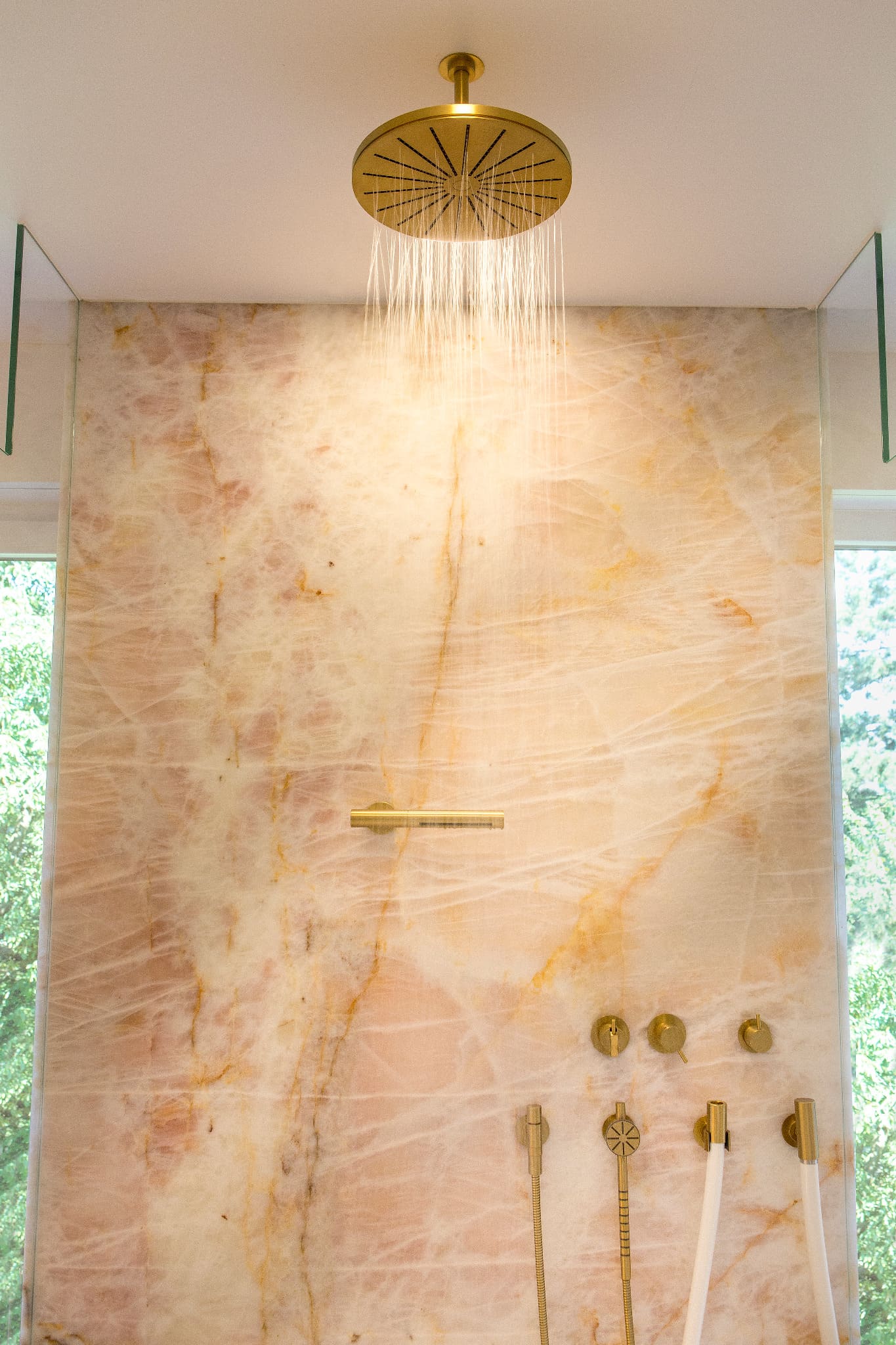 Luxusbad mit integrierter Naturstein-Dusche und technisch koordinierter Licht- und Wasserplanung im Premiumsegment